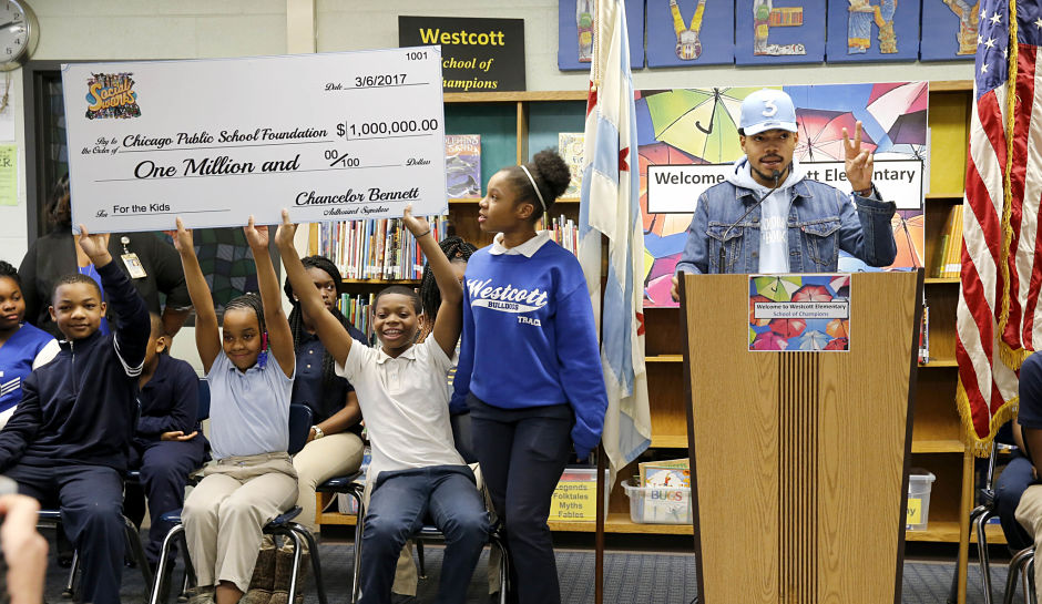 Chance The Rapper, right, announces a gift of $1 million to the Chicago Public School Foundation during a news conference at the Westcott Elementary School, Monday, March 6, 2017, in Chicago. The Grammy-winning artist is calling on Illinois Gov. Bruce Rauner to use executive powers to better fund Chicago Public Schools. (AP Photo/Charles Rex Arbogast)