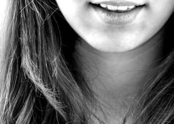 woman smiling in grayscale photography
